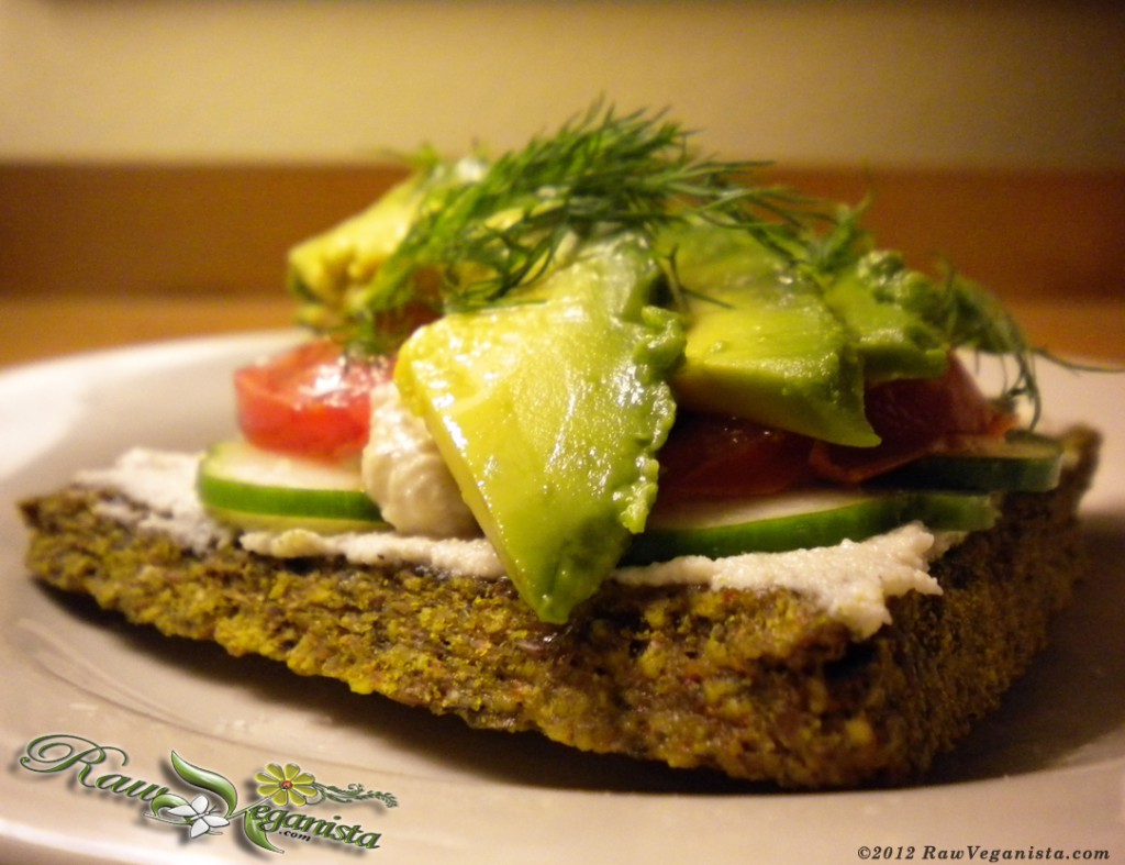 Macadamia nut hoummous open-faced sandwich on sunflower bread w/fresh seasonal produce